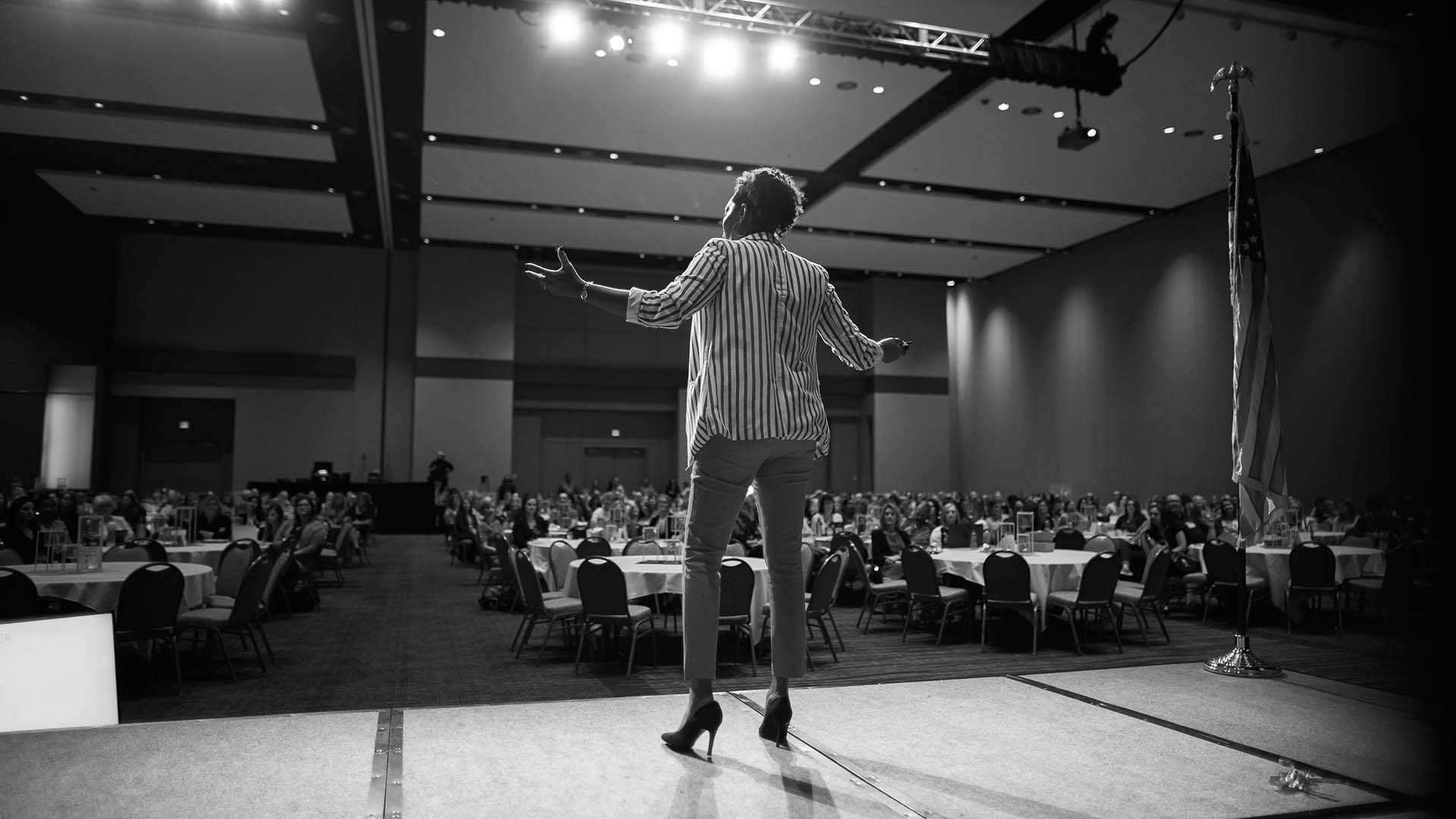 Risha Grant Speaking at Large Event Hall